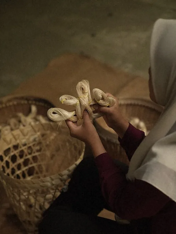 Hands preparing natural fibre