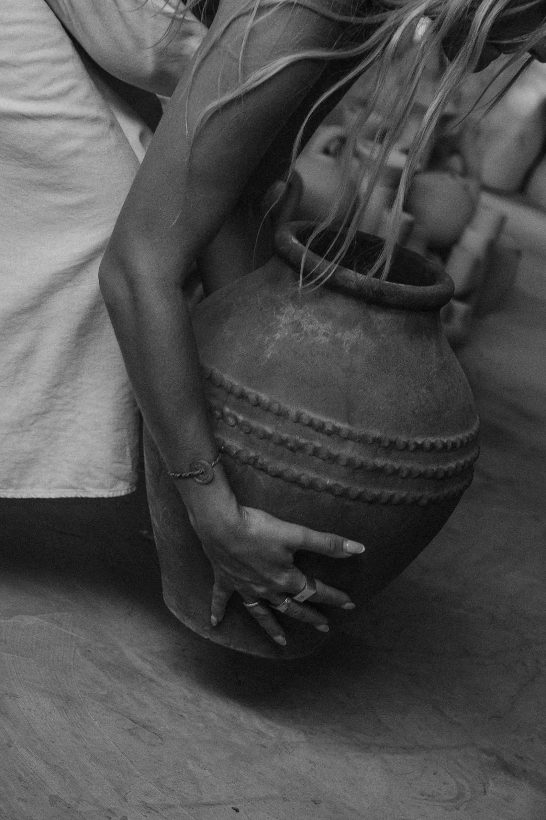 Carrying a hand-thrown vessel through the workshop