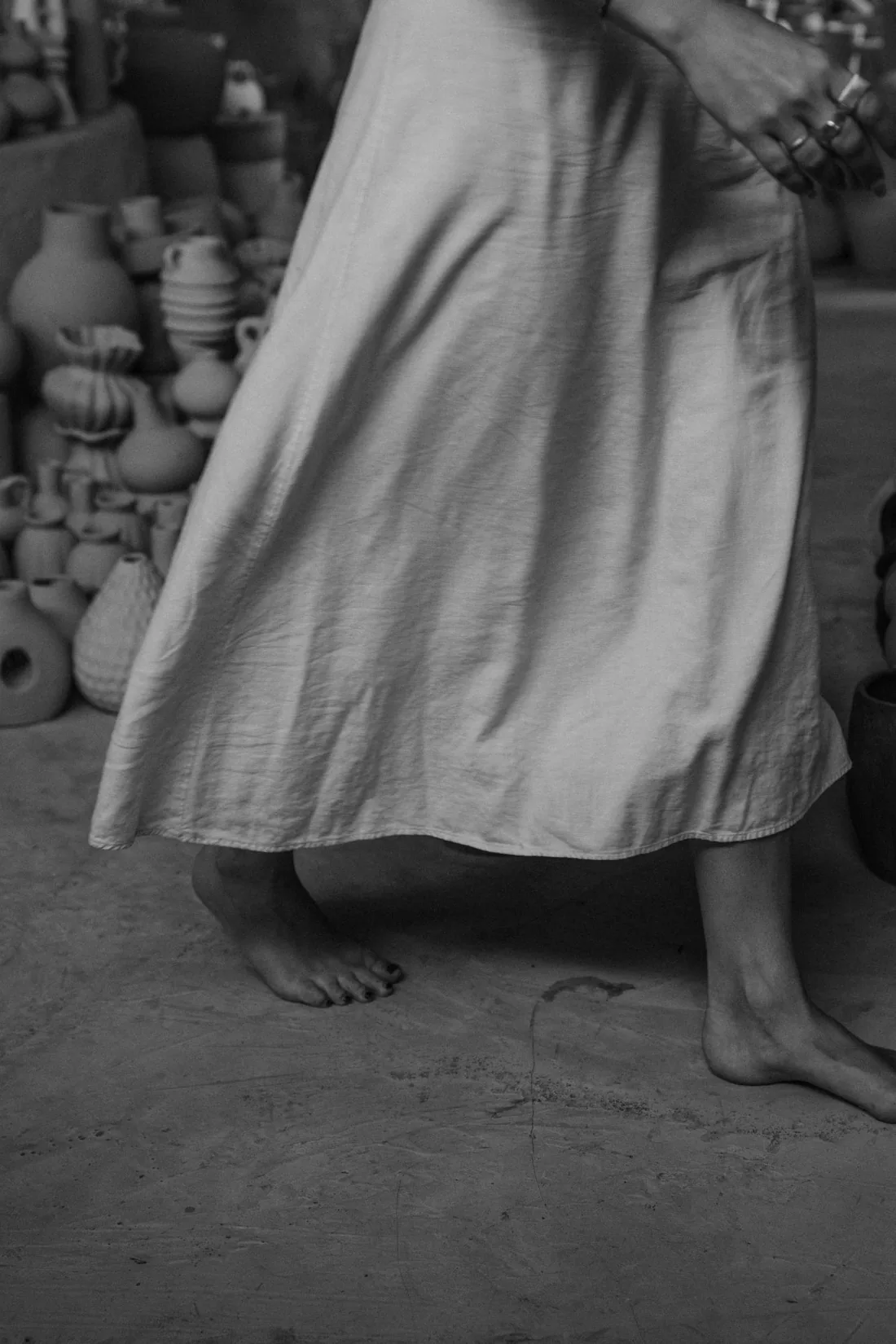 Walking barefoot among clay pieces in the pottery workshop