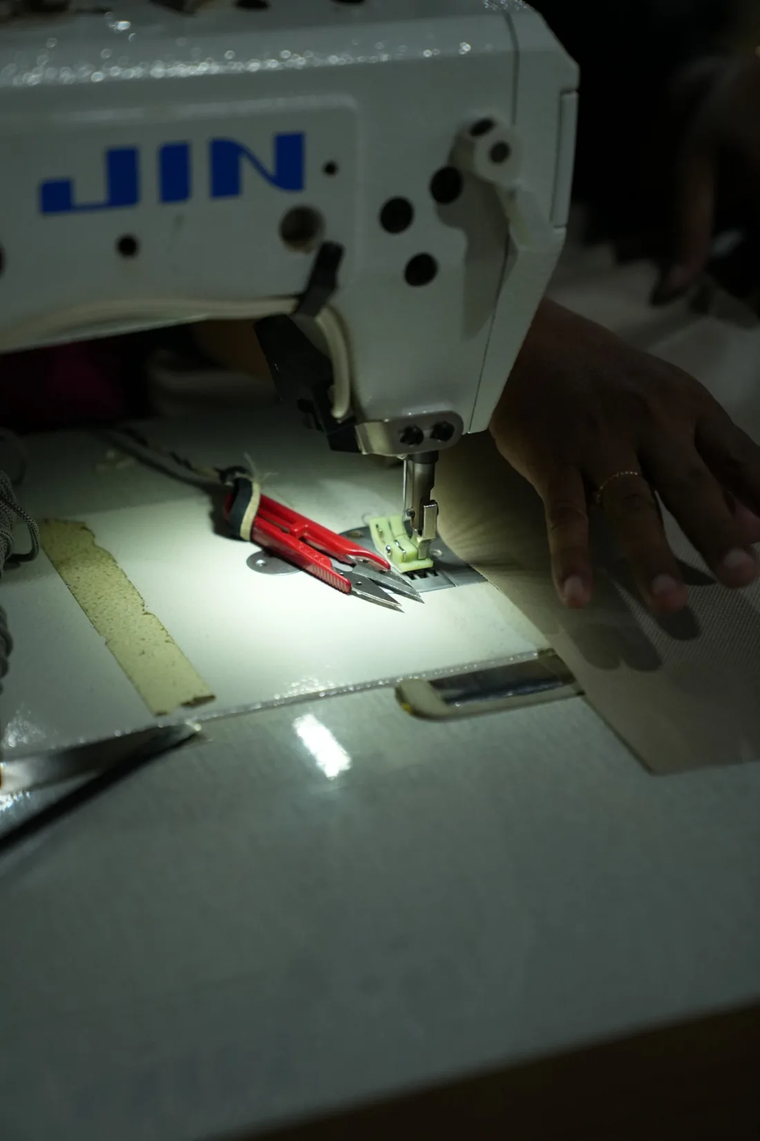 A seamstress at work on upholstery fabric