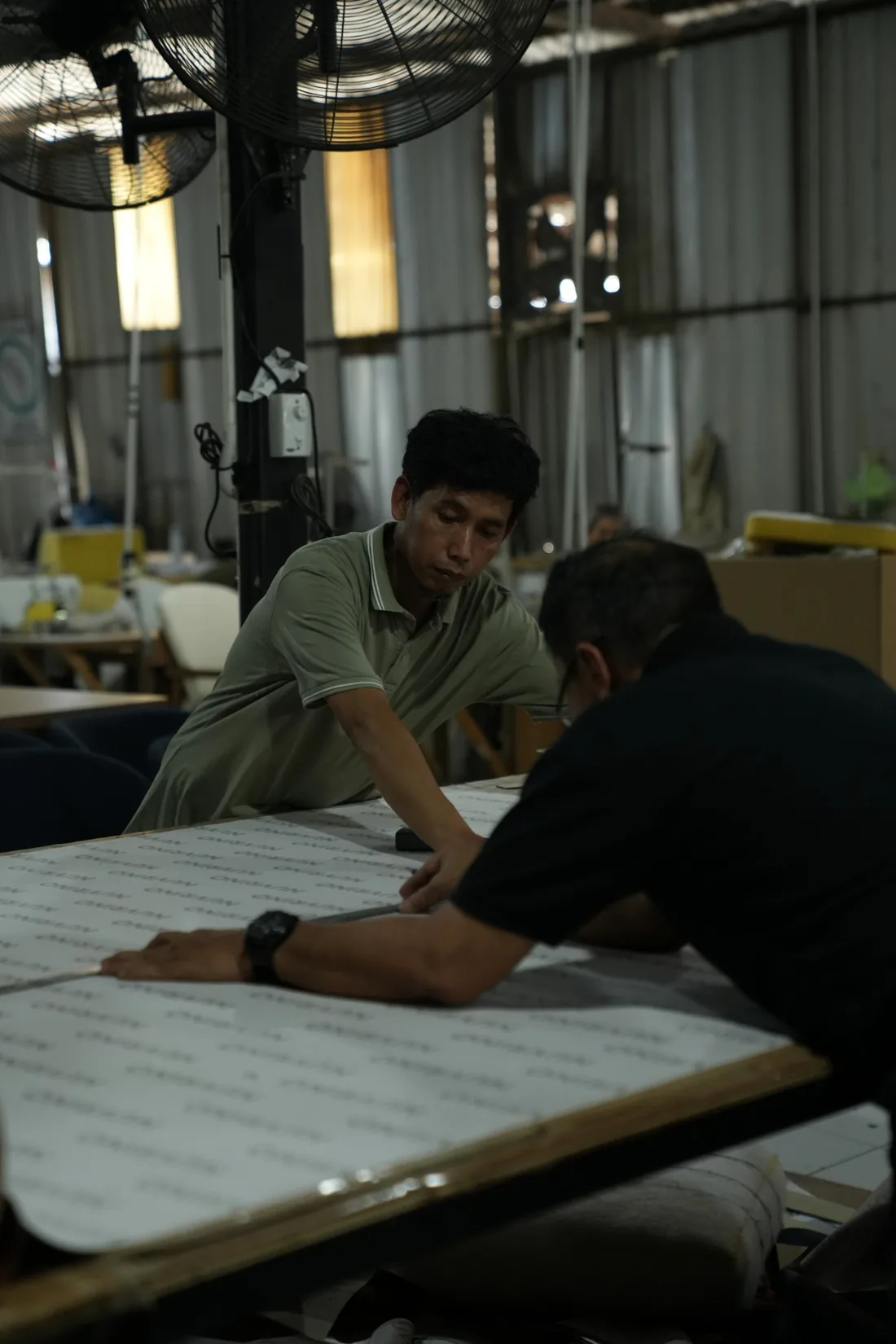 Upholsterers cutting a pattern