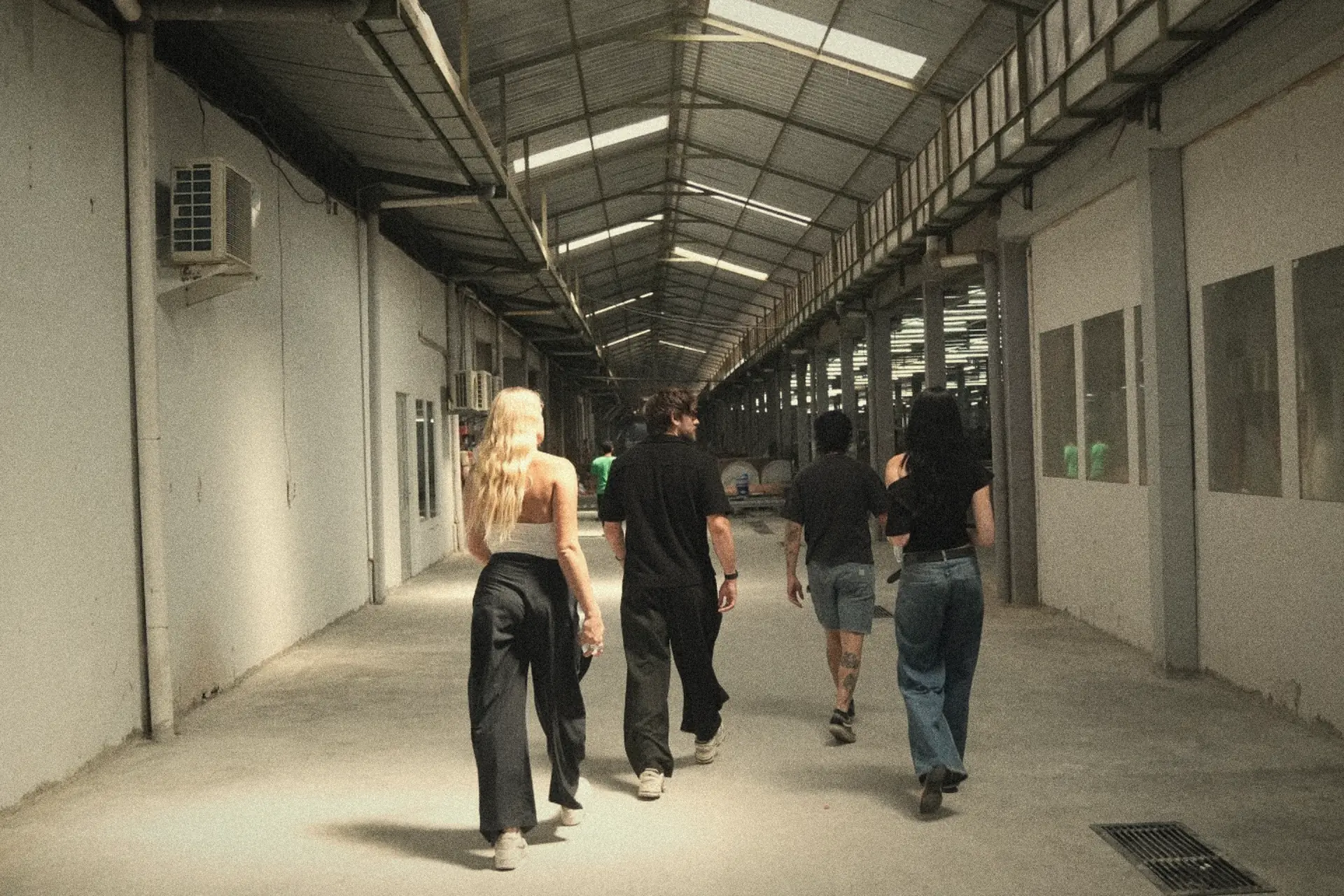 The House of Morphosis team walking through a supplier's factory