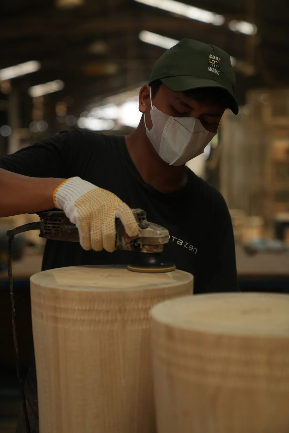 A craftsman sanding solid timber